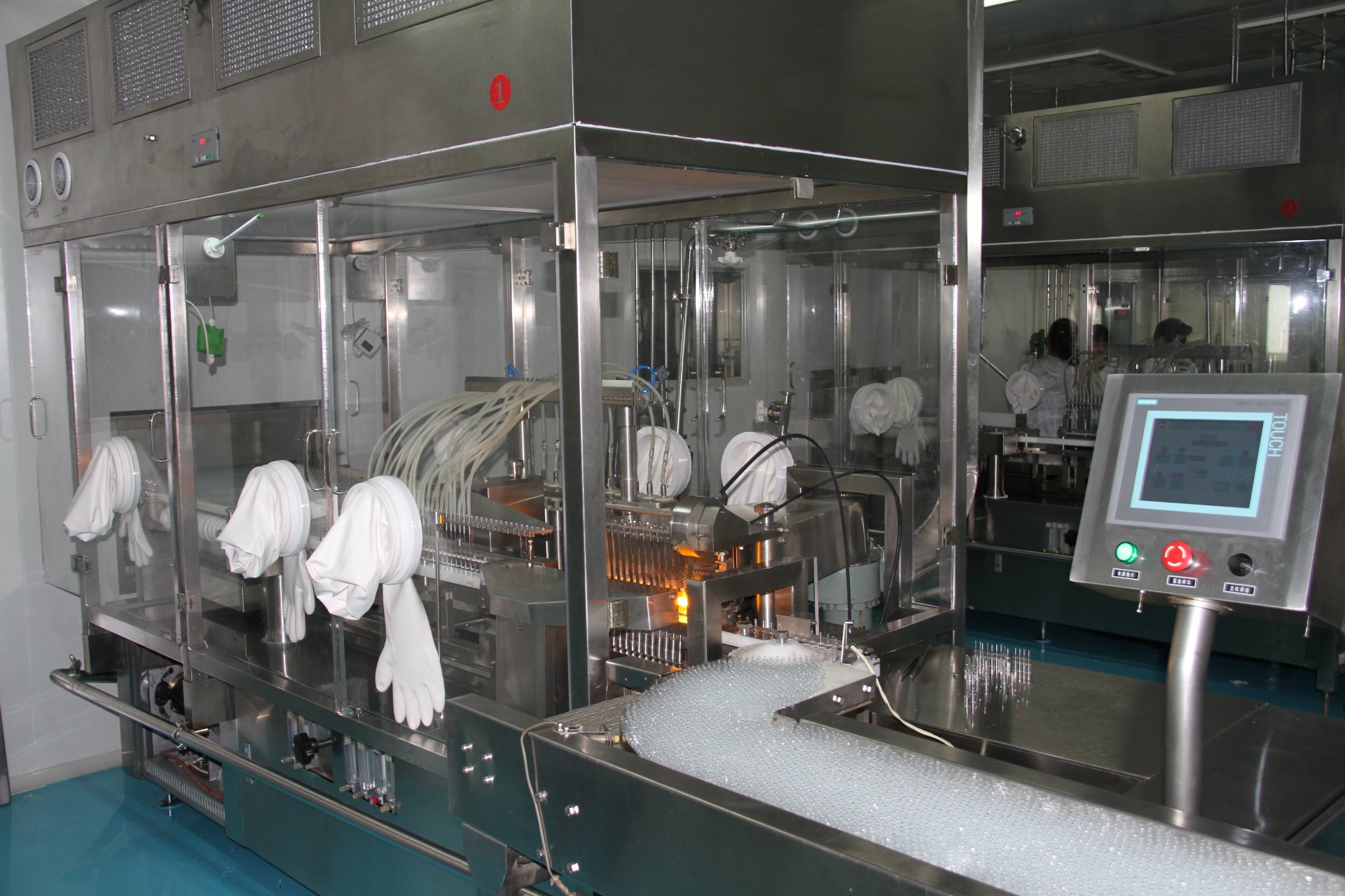 Aseptic ampoule filling line with glove ports and laminar flow hood