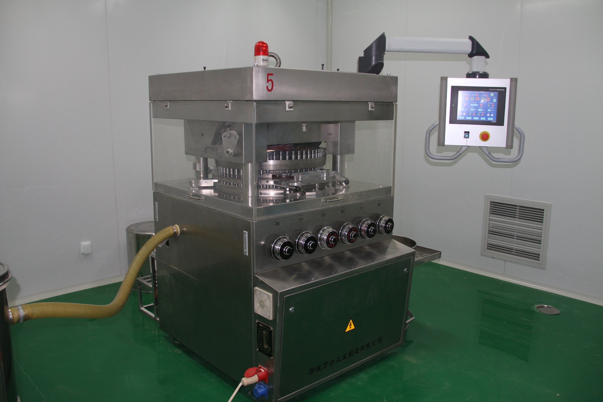 Rotary tablet press machine in cleanroom with green epoxy floor